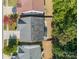 Aerial view of a house with a gray roof and small fenced backyard and patio near mature trees at 9904 Rocky Ford Club Rd, Charlotte, NC 28269