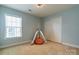 Cozy bedroom featuring a striped teepee, soft carpet, and a closet for added comfort at 9904 Rocky Ford Club Rd, Charlotte, NC 28269