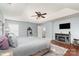 A spacious bedroom features a tray ceiling, fan, fireplace, TV, and an arched mirror at 9904 Rocky Ford Club Rd, Charlotte, NC 28269