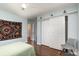 This bedroom features a double closet, hardwood floors, a ceiling fan, and plenty of natural light at 9904 Rocky Ford Club Rd, Charlotte, NC 28269