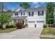 Charming two-story home with a well-manicured lawn, mature trees, and a three-car garage at 9904 Rocky Ford Club Rd, Charlotte, NC 28269