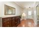 The foyer includes a beautiful wooden cabinet, mirror, hardwood floors, and a modern doorway at 9904 Rocky Ford Club Rd, Charlotte, NC 28269