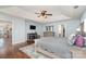 Main bedroom with hardwood floors, fire place, TV, ceiling fan, dresser, and lots of space at 9904 Rocky Ford Club Rd, Charlotte, NC 28269