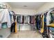 Spacious walk-in closet equipped with shelves, hanging racks, and a mirrored accent table at 9904 Rocky Ford Club Rd, Charlotte, NC 28269