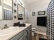Well-lit bathroom featuring a double vanity, updated fixtures, and decorative mirrors at 1009 Preston Dr, Lowell, NC 28098