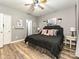 Well-lit bedroom with hardwood floors, ceiling fan, and a comfortable bed at 1009 Preston Dr, Lowell, NC 28098
