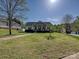 A beautiful home with a well maintained front lawn and landscaping on a sunny day with blue sky at 1009 Preston Dr, Lowell, NC 28098