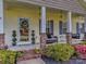 Inviting front porch featuring a comfortable sitting area, well manicured plants, and a beautifully decorated front door at 1009 Preston Dr, Lowell, NC 28098