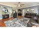 Spacious living room featuring hardwood floors, ample seating, and a ceiling fan at 1009 Preston Dr, Lowell, NC 28098