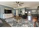 An open concept living room with beautiful hardwood floors and connected dining room area at 1009 Preston Dr, Lowell, NC 28098