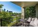 Relaxing balcony view with an outdoor table and seating overlooking trees and skyline at 1101 W 1St St # 405, Charlotte, NC 28202