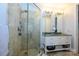 Elegant bathroom with double sink, glass shower, and neutral finishes at 1101 W 1St St # 405, Charlotte, NC 28202