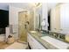 Bathroom with double sink vanity, glass shower, and a large mirror at 1101 W 1St St # 405, Charlotte, NC 28202