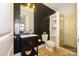 Modern bathroom featuring black accent wall, storage shelving and glass door shower at 1101 W 1St St # 405, Charlotte, NC 28202
