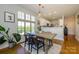 Bright dining area featuring wood floors, modern light fixture, and large window with natural light at 1101 W 1St St # 405, Charlotte, NC 28202