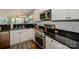 Updated kitchen featuring stainless steel appliances, dark countertops, and sleek white cabinetry at 1101 W 1St St # 405, Charlotte, NC 28202