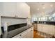 Open concept kitchen with white cabinets, stainless steel appliances, and an island at 1101 W 1St St # 405, Charlotte, NC 28202