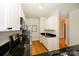 Open concept kitchen featuring black countertops, stainless steel appliances and white cabinets at 1101 W 1St St # 405, Charlotte, NC 28202