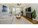 Well-lit living room featuring hardwood floors, a ceiling fan, and large windows at 1101 W 1St St # 405, Charlotte, NC 28202