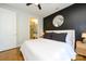 Chic bedroom with ensuite bathroom, dark accent wall, wood floors and ceiling fan at 1101 W 1St St # 405, Charlotte, NC 28202