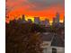 City skyline view at sunset, with a fiery orange sky behind the buildings at 1101 W 1St St # 405, Charlotte, NC 28202