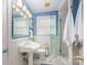 Charming bathroom with classic fixtures, a tiled shower, and bright blue walls at 1114 Hartford Ave, Charlotte, NC 28209