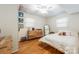 Cozy bedroom with unique decor, hardwood floors, and ample natural light at 1114 Hartford Ave, Charlotte, NC 28209