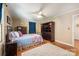Comfortable bedroom featuring a wrought iron bed frame, hardwood floors, and ample storage space at 1114 Hartford Ave, Charlotte, NC 28209