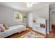 Cozy bedroom features hardwood floors, a charming window, and a unique house-shaped bookshelf at 1114 Hartford Ave, Charlotte, NC 28209