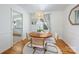 Bright dining room featuring a round wood table, stylish chairs, and natural light from a nearby window at 1114 Hartford Ave, Charlotte, NC 28209
