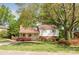 Charming home with mature trees and landscaping, featuring a well-maintained lawn and inviting entrance at 1114 Hartford Ave, Charlotte, NC 28209