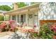 Inviting front porch with brick flooring, lovely decorative columns, and a charming entrance and plantings at 1114 Hartford Ave, Charlotte, NC 28209