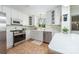 Well-lit kitchen with white cabinetry, stainless steel appliances, and a functional layout for cooking and entertaining at 1114 Hartford Ave, Charlotte, NC 28209