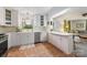 Functional kitchen with white cabinets, stainless steel dishwasher, and ample counter space for meal preparation at 1114 Hartford Ave, Charlotte, NC 28209