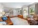 Inviting living room featuring hardwood floors, a staircase, and natural light at 1114 Hartford Ave, Charlotte, NC 28209