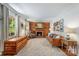 Warm living room with a brick fireplace, wood paneling, and comfortable seating at 1114 Hartford Ave, Charlotte, NC 28209