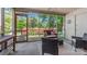 Relaxing screened porch with comfortable seating and views of the colorful, landscaped backyard at 1114 Hartford Ave, Charlotte, NC 28209