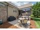Outdoor patio with grilling and dining area, perfect for entertaining friends, with pine straw landscaping at 115 Ladybug Ct, Statesville, NC 28625