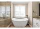 This bathroom features a modern soaking tub next to a glass enclosed shower with tile surround at 115 Ladybug Ct, Statesville, NC 28625