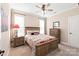 This bedroom features a ceiling fan, a bed with matching furniture, and carpeted floors at 115 Ladybug Ct, Statesville, NC 28625