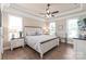 Bright and airy bedroom features a ceiling fan, hardwood floors, and lots of natural light at 115 Ladybug Ct, Statesville, NC 28625