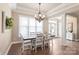 Formal dining room features hardwood floors, chandelier, and lots of natural light at 115 Ladybug Ct, Statesville, NC 28625