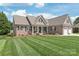 A charming brick home with a well-manicured lawn and inviting front porch at 115 Ladybug Ct, Statesville, NC 28625