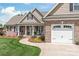 Inviting brick home with covered front porch and beautiful landscaping at 115 Ladybug Ct, Statesville, NC 28625