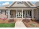 Charming front porch with brick columns and rocking chairs at 115 Ladybug Ct, Statesville, NC 28625