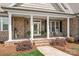 Close up of a welcoming front porch with rocking chairs and decorative plants at 115 Ladybug Ct, Statesville, NC 28625