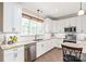 Bright kitchen featuring granite countertops, subway tile backsplash, stainless appliances, and hardwood floors at 115 Ladybug Ct, Statesville, NC 28625
