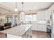 A bright kitchen features stainless steel appliances, granite countertops, and an island with bar seating at 115 Ladybug Ct, Statesville, NC 28625