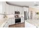 Bright kitchen featuring granite countertops, subway tile backsplash, and stainless appliances at 115 Ladybug Ct, Statesville, NC 28625