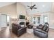 Spacious living room features a fireplace, ceiling fan, hardwood floors and comfortable leather seating at 115 Ladybug Ct, Statesville, NC 28625